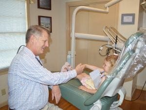 Dale Probst, DMD - Family Dentist - Looking at Child's teeth