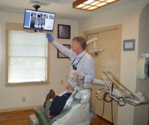 Dale Probst checking x-rays of teeth
